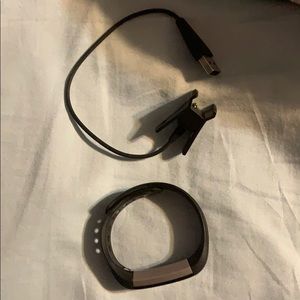 Black fitbit alta with charger